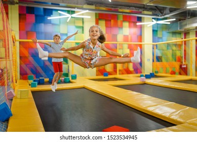 Little girl and boy having fun on kids trampoline - Shutterstock ID 1523534945