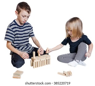 Little Girl And Boy Playing Blocks Jenga Isolated On White Background