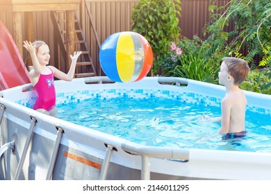 Little girl and boy plays an colorful inflatable ball in swimming pool outdoor, having fun. Pool toys and water fun children. - Shutterstock ID 2146011295