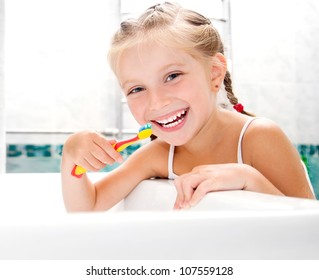 Little Girl Brushing Teeth In Bath