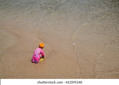The little girl building sand