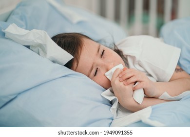 The Little Girl Caught A Cold. Children Sneeze Into A Handkerchief. The Child Is Ill And Is Being Treated At Home. Seasonal Colds In Children