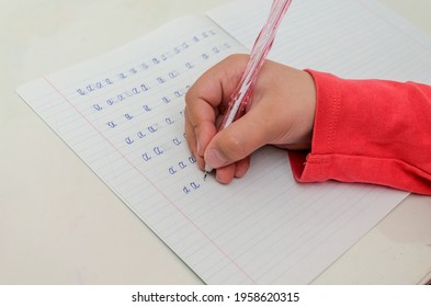 Little girl child doing homework, learning to write letters	
 - Powered by Shutterstock