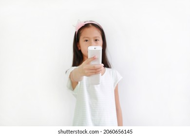 Little Girl Child Holding Remote Control Over White Background. Focus At Remote In His Hand.