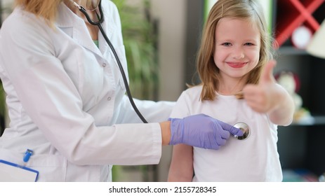 Little Girl Child Making Thumbs Up Gesture At Doctor Appointment. Medina Child Insurance Concept