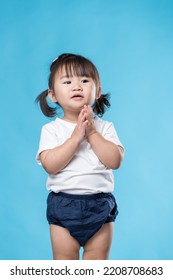Little girl clap over blue background - Shutterstock ID 2208708683
