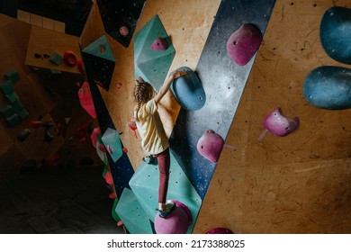 Little Girl Climber Training In A Modern Indoor Rock Climbing Gym. Kids Sport Activities. Selective Focus.