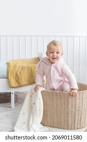 Little Girl Climbing In A Laundry Basket