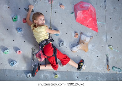 Little Girl Climbing A Rock Wall Indoor