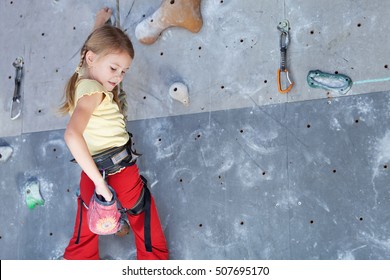 Little Girl Climbing A Rock Wall Indoor