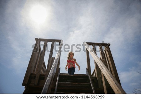 Similar – Image, Stock Photo Little girl climbing to a wooden observation tower in a wetland