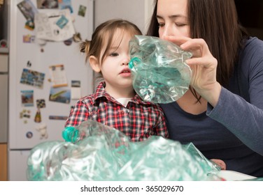 Little girl collecting plastic for recycling with her mother - Powered by Shutterstock