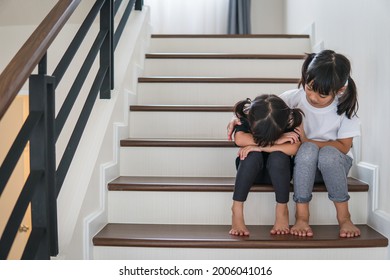 Little girl comforting her sister at home