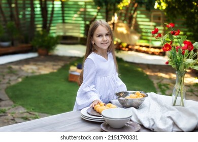 Little Girl Cooking Breakfast In Garden Summer. Happy Child With Fruit In A Colander On A Wooden Table In Backyard. Kid Enjoy Summer Picnic, Cute Girl In Lunch Outside 
