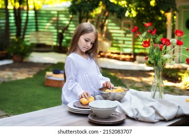 Little Girl Cooking Breakfast In Garden Summer. Happy Child With Fruit In A Colander On A Wooden Table In Backyard. Kid Enjoy Summer Picnic, Cute Girl In Lunch Outside 
