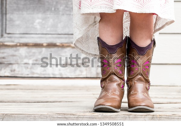 little girl in cowboy boots