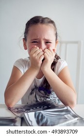 little girl crying doing homework