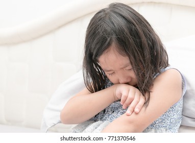 Little girl crying on bed, sad and angry concept