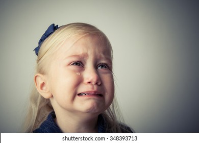 Little girl crying. Really upset. Tears on her cheek