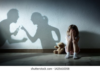 Little Girl Crying With Shadow Of Parents Arguing - Home Violence And Divorce