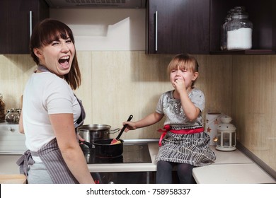 Little Girl Crying While Cooking With Her Mother. Toddler Throwing A Tantrum In The Kitchen.