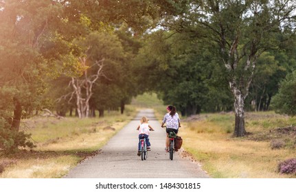 Little Girl Cycling With Her Mother In Holland
