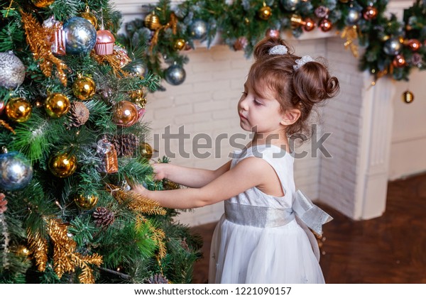 Little Girl Decorating Christmas Tree On Stock Photo Edit