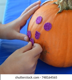 Little Girl Decorating Pumpkin 