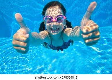 Little Girl Dives Into The Water And Shows The Gesture OK