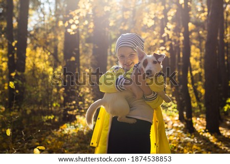 Similar – Foto Bild Herbstporträt eines glücklichen Kindes Mädchens, das mit ihrem Hund spielt.