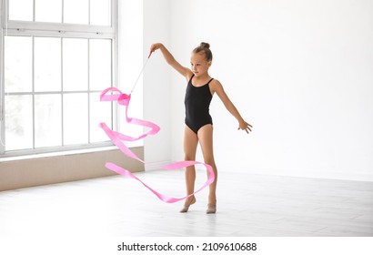 Little Girl Doing Gymnastics With Ribbon In Gym