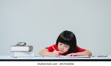 Little Girl Doing Homework, Kid Writing Paper On White Background, Education Concept
