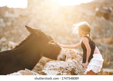 Little Girl With Donkey On The Greek Island