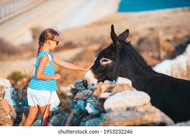 little-girl-donkey-on-island-260nw-1953232246.jpg