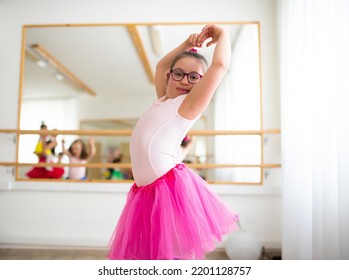 Little girl with down syndrome at ballet class in dance studio. Concept of integration and education of disabled children. - Powered by Shutterstock