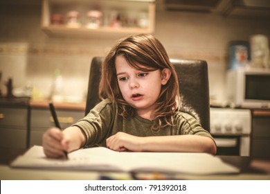 Little girl draw in kitchen. Close up. - Powered by Shutterstock