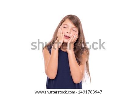 Little girl dreams closing her eyes isolated on a white background.