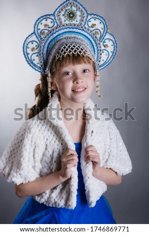 A little girl dressed as Snow Maiden