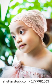 Little Girl Dressing Up In A Ballerina Costume. Asian Toddler Pretend Play.