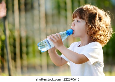 Little Girl Drinking Clean Water From Bottle