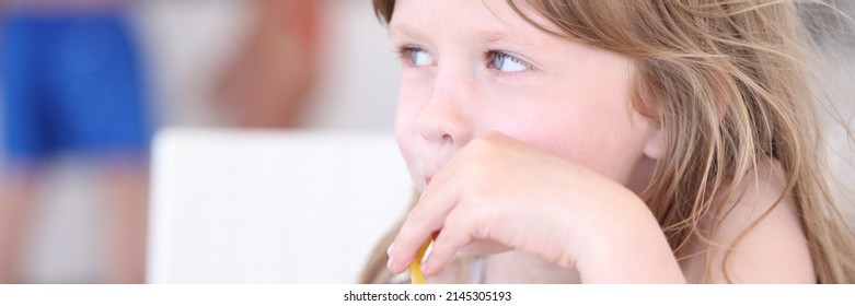 Little girl drinking nonalcoholic cocktail from straw at beach bar - Shutterstock ID 2145305193