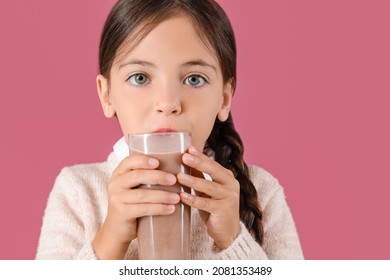 Little Girl Drinking Tasty Chocolate Milk On Color Background