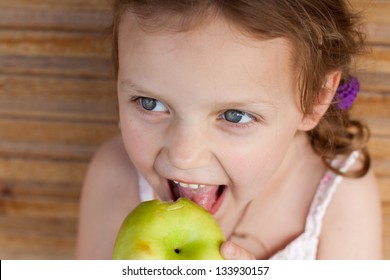 little girl eating an apple