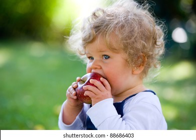 Little Girl Is Eating A Apple