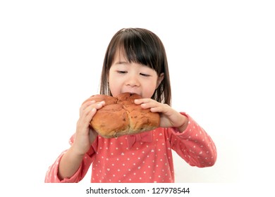 Little Girl Eating A Bread