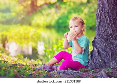 Little Girl Eating Bread Rolls