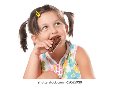 Little girl eating cereal bar for snack isolated on white background