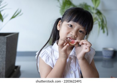 Little Girl Eating Gummy Candy. Children Vitamin. Candies.