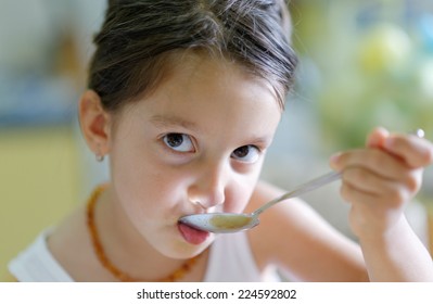 Little girl eating healthy cooked food and enjoy