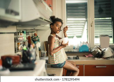Little girl is eating her breakfast